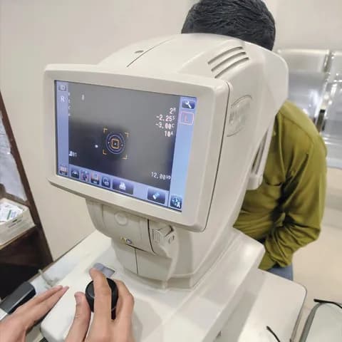 An eye examination being conducted using an automated refraction machine.